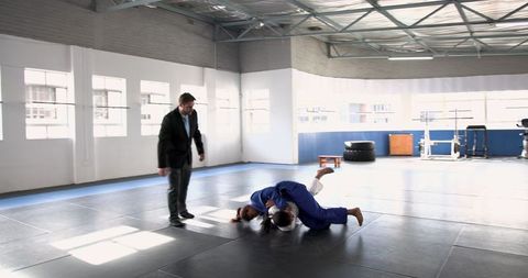Teenage Girls Training Jiu-Jitsu Watched by Coach