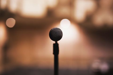 Microphone in spotlight with blurry background
