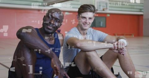 Resting Athletes Sitting Together Indoors in Sports Arena