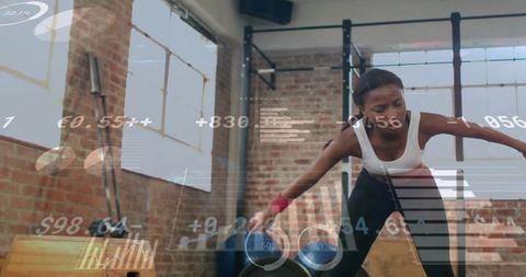 Leaning fit woman training kettlebell strength workout in loft with futuristic hud overlay