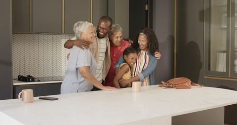 Multigenerational family sharing warm embrace at modern kitchen island, joyful lifestyle