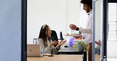 Office Celebration with Co-workers Sharing Cake