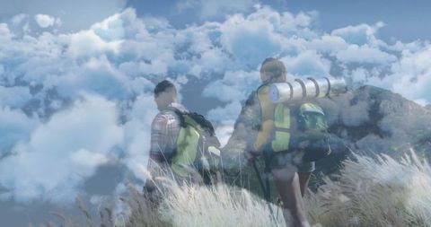 Hikers Exploring Grassy Ridge Under Expansive Clouded Sky