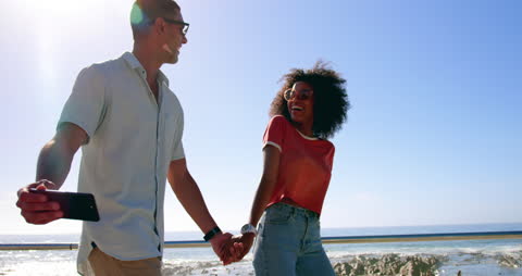 Joyful Couple Taking Selfie on Sunny Beach Walk