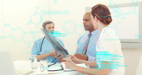 Doctors Analyzing X-Ray with Data Overlay in Modern Office