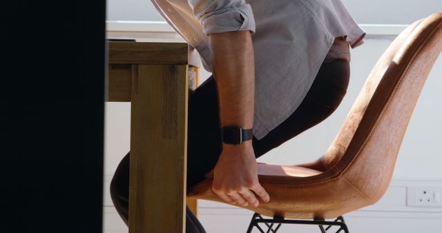 Person Adjusting Chair at Desk in Office - Download Free Stock Images Pikwizard.com