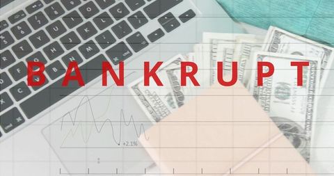 Red bankrupt overlay showing office flatlay with laptop, cash, pastel notebook and finance chart