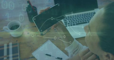 Analyst Analyzing Data on Smartphone with Laptop and Notebook