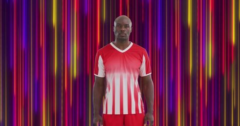 Athlete Posing Against Vivid Striped Background for Sports Promotion