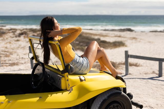 Woman Relaxing on Beach Buggy by the Sea - Download Free Stock Photos Pikwizard.com