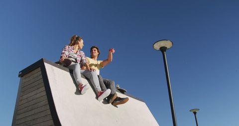 Friends Hanging Out at Skate Park Skyline At Dusk - Download Free Stock Images Pikwizard.com