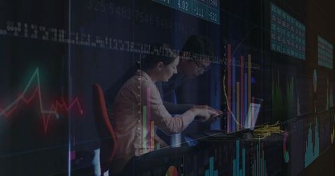 Business Professionals Analyzing Financial Data on Laptop in Trading Room
