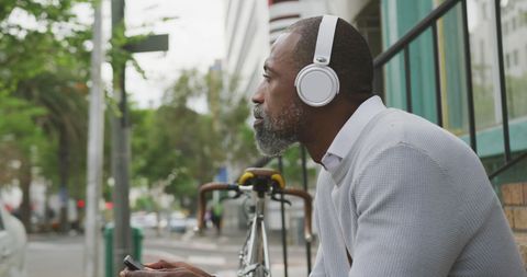 Urban Lifestyle: Man With Headphones Using Smartphone Outdoors - Download Free Stock Images Pikwizard.com