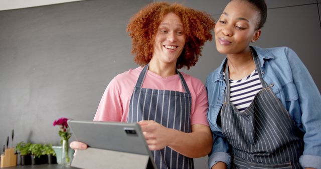 Cheerful young friends cooking together using digital tablet - Download Free Stock Images Pikwizard.com