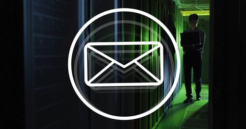 Technician monitoring digital communications in dark server room