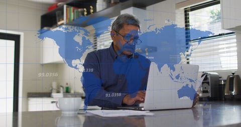 Senior Man Using Laptop with Digital World Map Overlay for Data Analysis