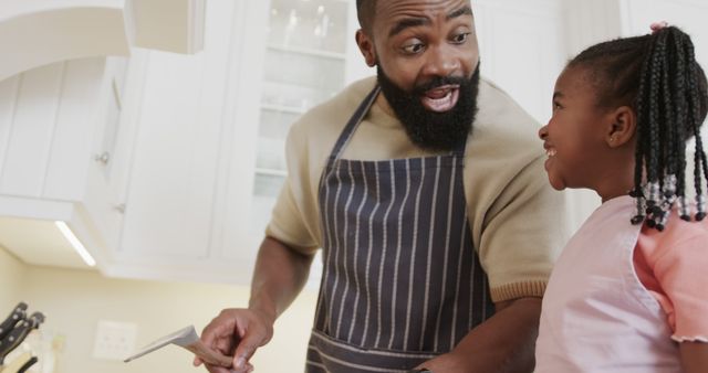 Father and Daughter Smiling in Kitchen while Cooking Together - Download Free Stock Images Pikwizard.com