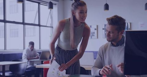 Professional collaboration in open-plan office setting