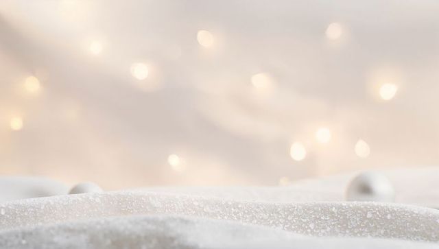 Shimmering ivory sequin fabric with warm bokeh lights and soft champagne glow