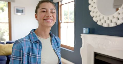 Smiling Teenage Girl Relaxing in Bright Modern Living Room