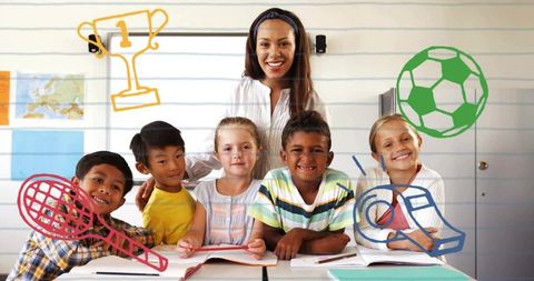 Smiling teacher standing behind diverse elementary students reading and learning together