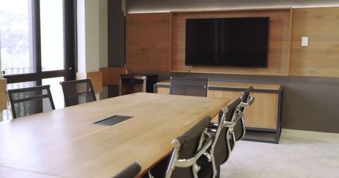 Modern conference room with wooden table and power outlet