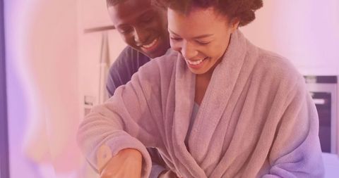 Affectionate couple cooking together in cozy kitchen interior