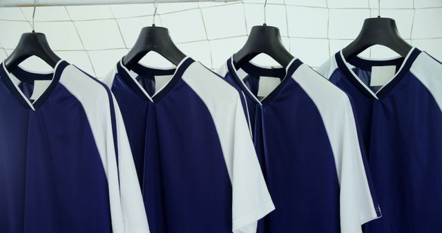 Four Blue and White Sports Jerseys Hanging on Black Hangers - Download Free Stock Images Pikwizard.com