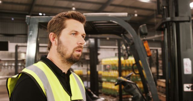 Warehouse Worker in Safety Vest Operating Forklift - Download Free Stock Images Pikwizard.com