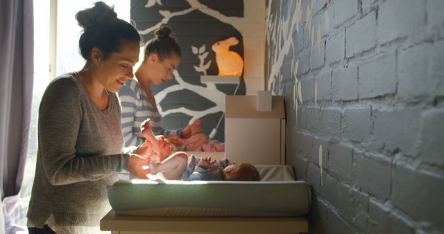 Mothers changing their babies' diapers in cozy nursery - Download Free Stock Images Pikwizard.com