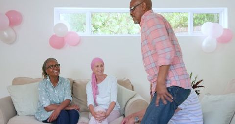 Family Celebration with Senior Man Lighting Cake Candles at Home