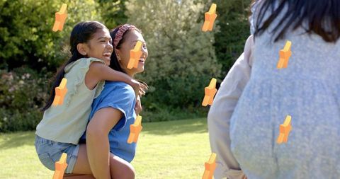 Woman carrying girl piggyback laughing together in sunlit backyard family joy