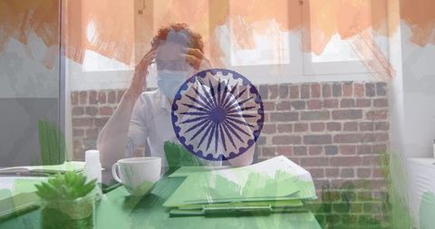 Stressed businessman in office with india flag overlay