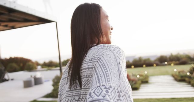 Smiling woman outdoors wrapped in patterned blanket enjoying the sunset - Download Free Stock Images Pikwizard.com