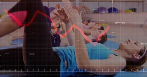 Women performing core crunches in group fitness class with red performance graph overlay