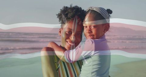 Loving Mother and Daughter Enjoying Beach Sunset