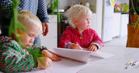 Father and Young Children Drawing Together Inside Cozy Home