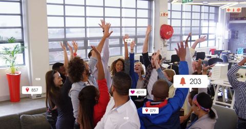 Diverse Team Celebrating in Modern Office with Social Media Data Graphics