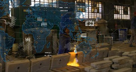 Foundry worker pouring molten metal into molds with crucible flame in industrial factory