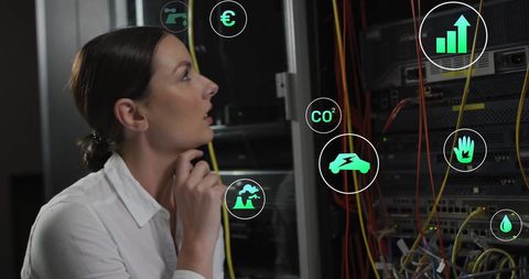 Businesswoman analyzing environmental data in server room