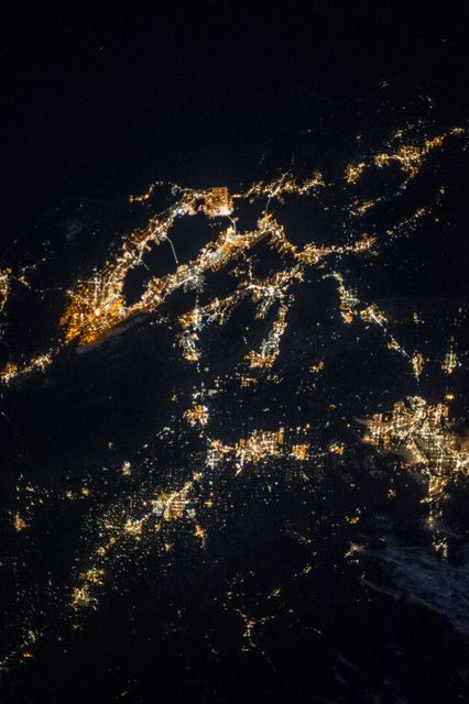 The photo, taken from the International Space Station on September 25, 2013, showcases the night lights of Northern California. Major cities like San Francisco, San Jose, Oakland, Modesto, and Stockton are easily identifiable due to their bright lights. This image can be used to highlight urban development, city infrastructure, or geographical studies, and is ideal for space exploration contexts.