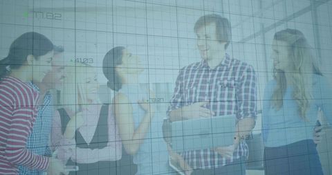 Office Team Collaborating on Laptop in Bright Workspace