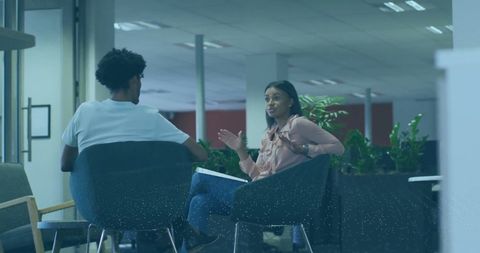 Business Conversation in Modern Office with Financial Data Overlay