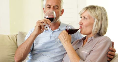 Mature Couple Relaxing With Wine at Home in Living Room - Download Free Stock Images Pikwizard.com