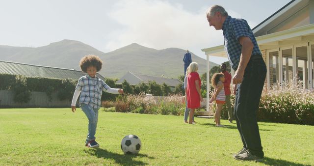 Image of diverse family in playing football match outside. Family life, spending time together with family.