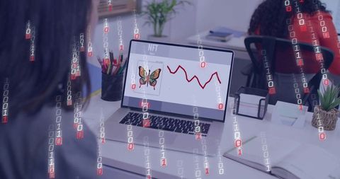 Coworkers analyzing NFT market on laptop showing butterfly artwork and falling red chart