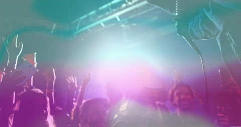 Energetic Crowd Enjoying Live Concert with Vibrant Lighting