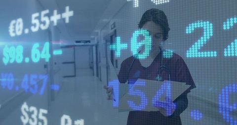 Nurse reviewing records in hospital corridor with financial data and currency overlay