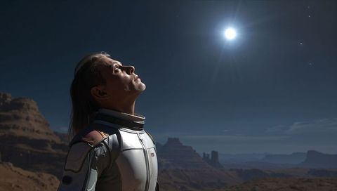Male Astronaut Gazing at Bright Planet over Desert Mesas and Buttes under Starry Night Sky