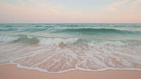 Gentle ocean waves at sunrise with pastel skies